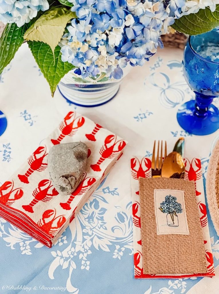 Lobster napkins and rock on table.