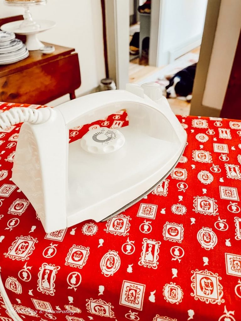 red table cloth being ironed.