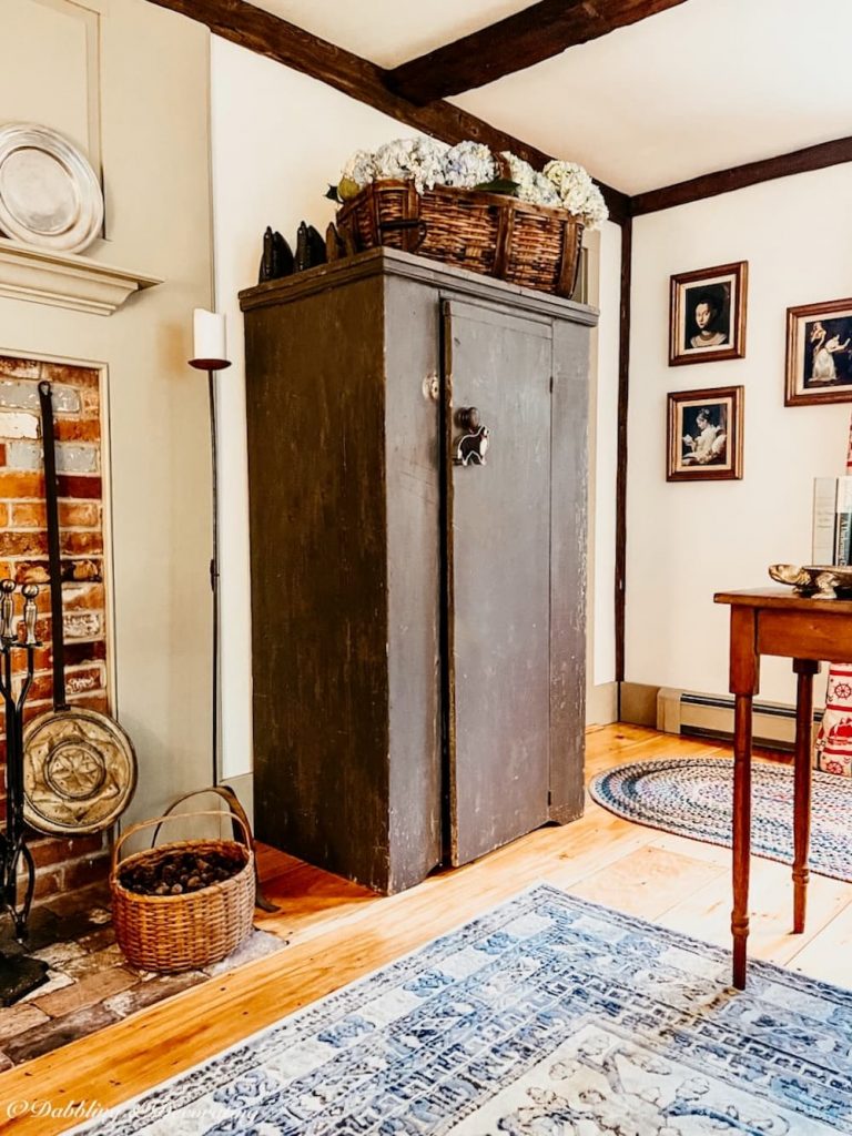 Colonial house design living room with antique cabinet.