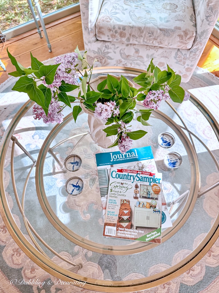 Looking down onto glass nesting tables with Country Sampler 40 Year Anniversary issue where our home was featured.