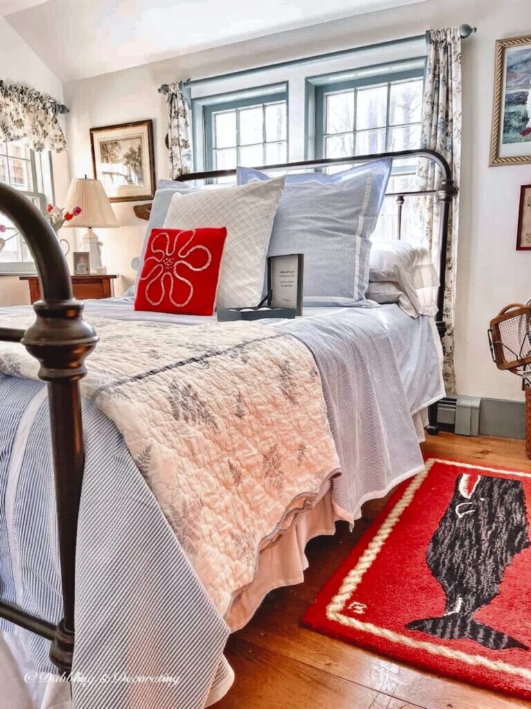 Coastal bedding displayed in guest bedroom with seersucker bedding and red details.