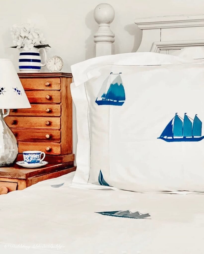 Coastal bedding ideas with Schweitzer Linen's Winward Collecting with blue embroidered sailboats and crisp white vibe.