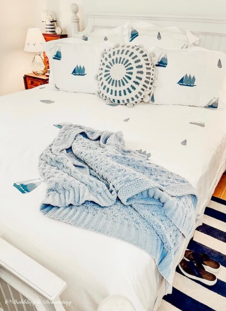 Coastal bedding ideas with Schweitzer Linen's Winward Collection in white wit blue embroidered sailboats.