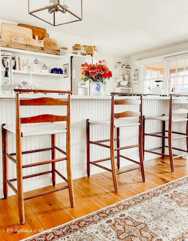 Open White Farmhouse Vintage Kitchen with shaker-style stools.