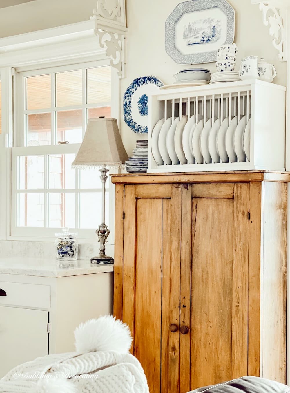 Farmhouse Cabinet in open farmhouse white kitchen with vintage style.