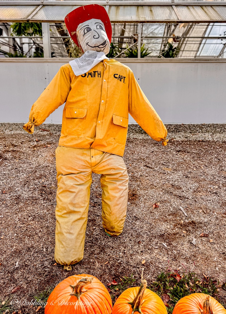Fisherman captain scarecrow dressed in yellow coat and pants.