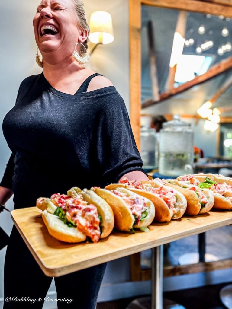 woman serving lobster rolls