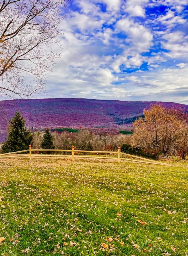 Mountain views with split rail fencing and pumpkins in the fall.