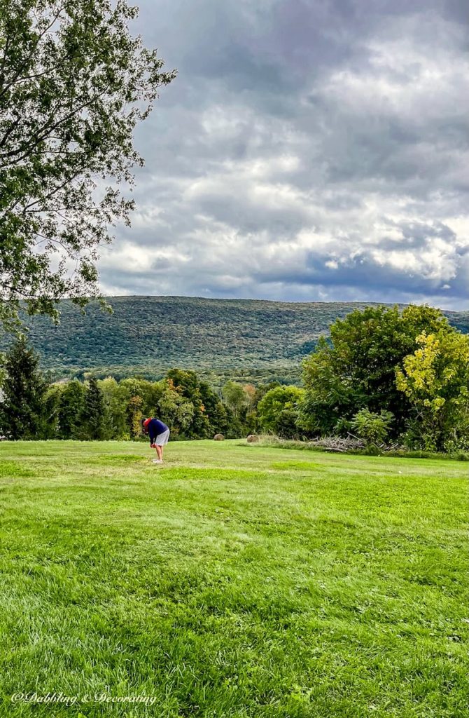 Mountain Views with Man measuring yard.