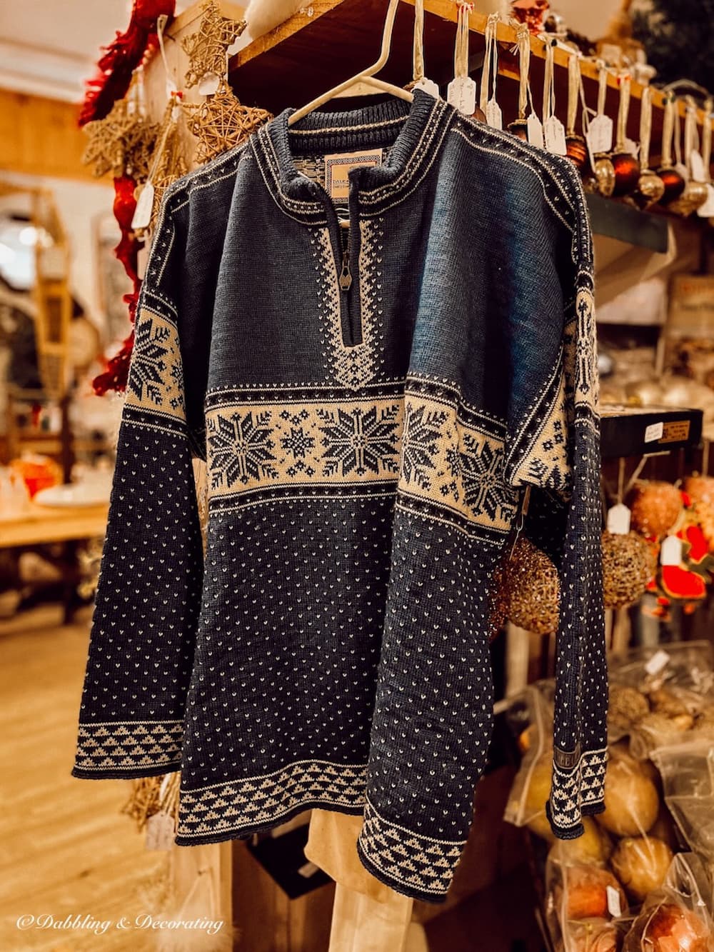 Vintage Blue Ski Sweater hanging in antique store.