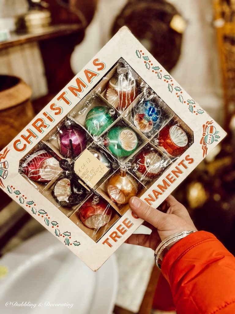 Antique box of Christmas treen ornaments in hand.