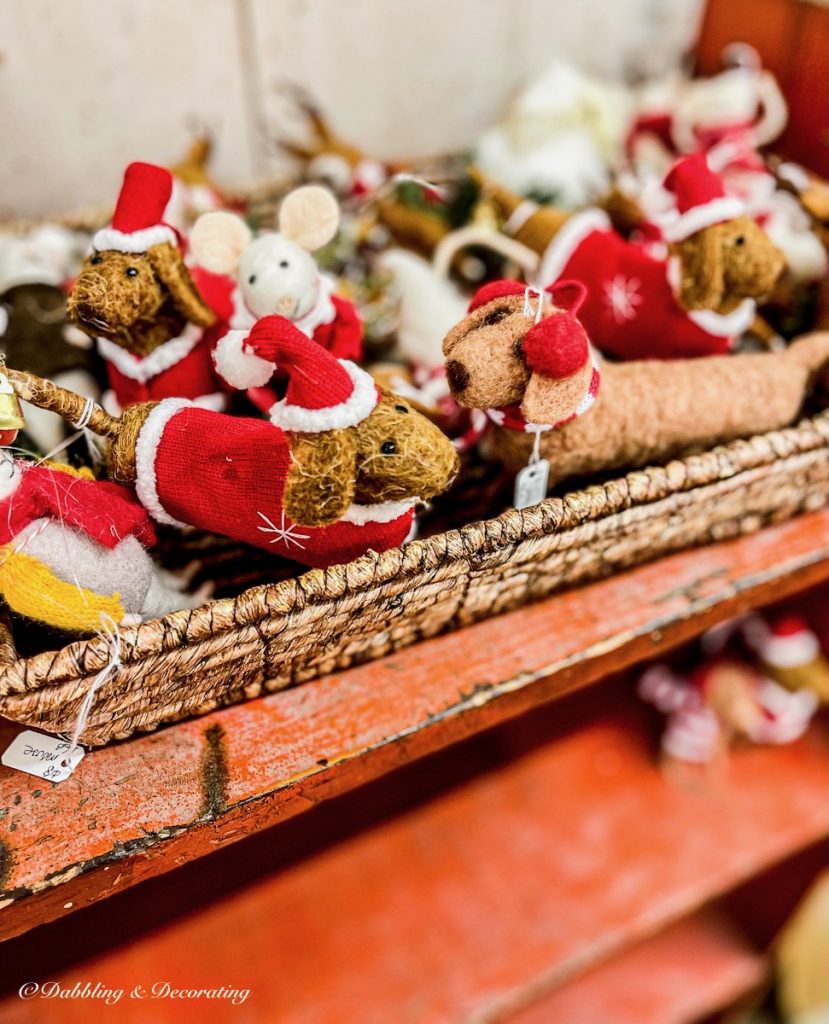 Miniature handmade dogs with santa suits in antique store.