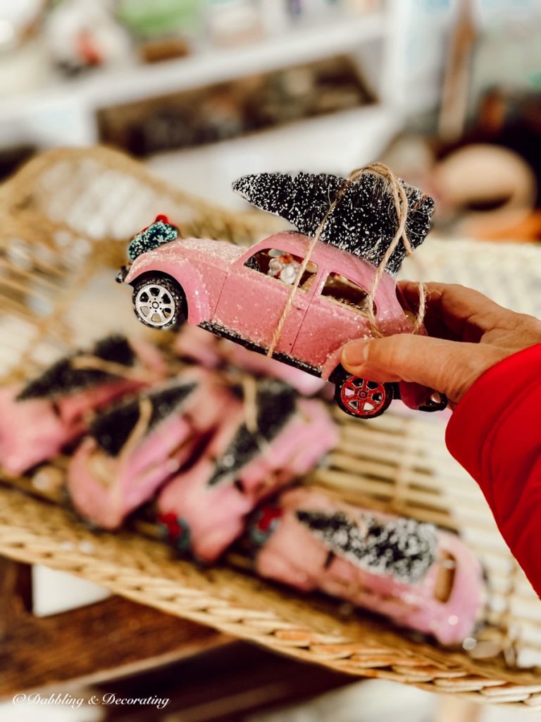 Small Pink Volkswagon with Christmas Tree.