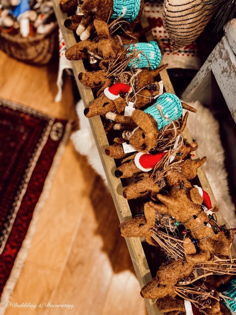 Miniature handmade dogs with santa suits in antique store.
