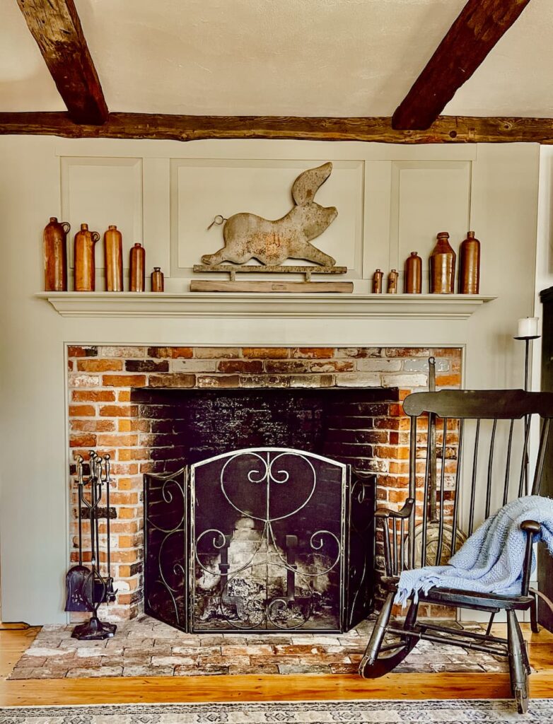 Fireplace with antique jug collection.