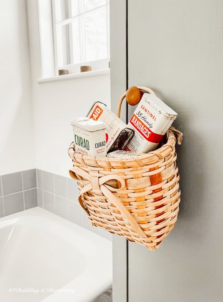 Vintage band aid tins in basket.