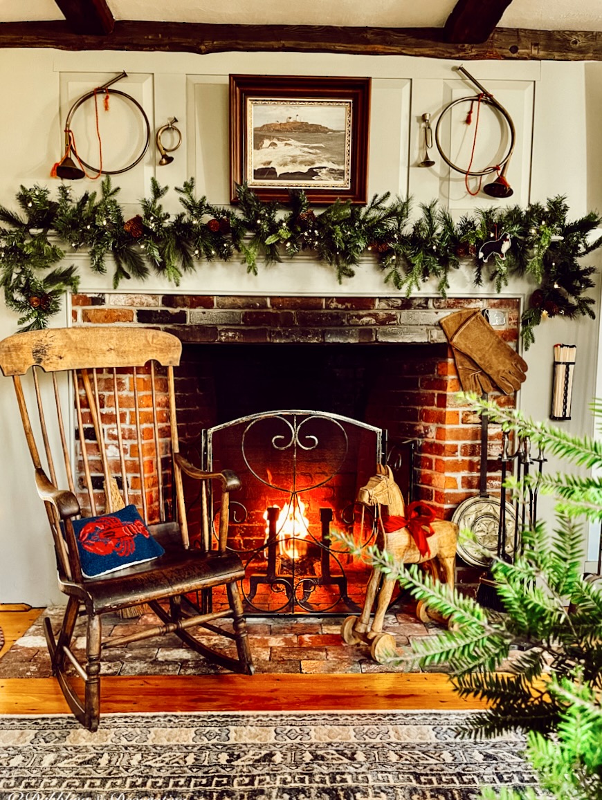 Christmas hearth and fireplace with rocking chair and antique bugles.