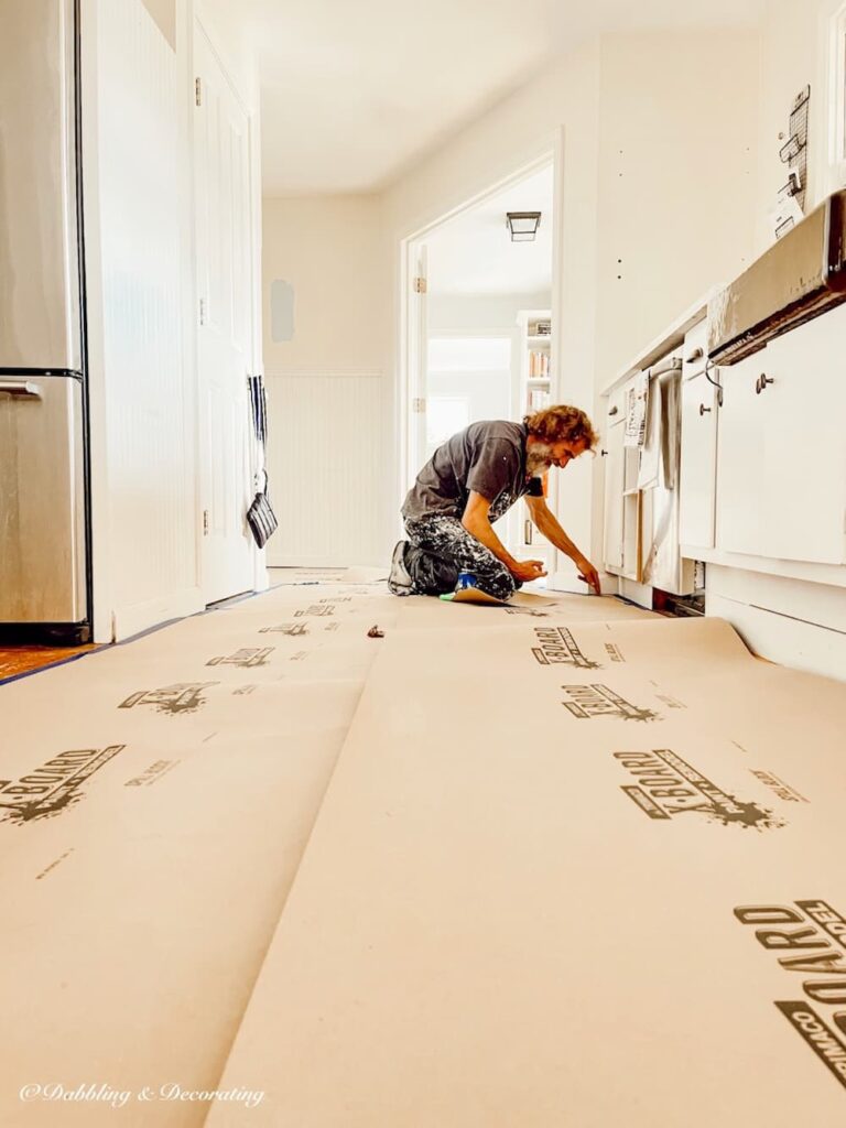 Painter on Floor Prepping flooring.