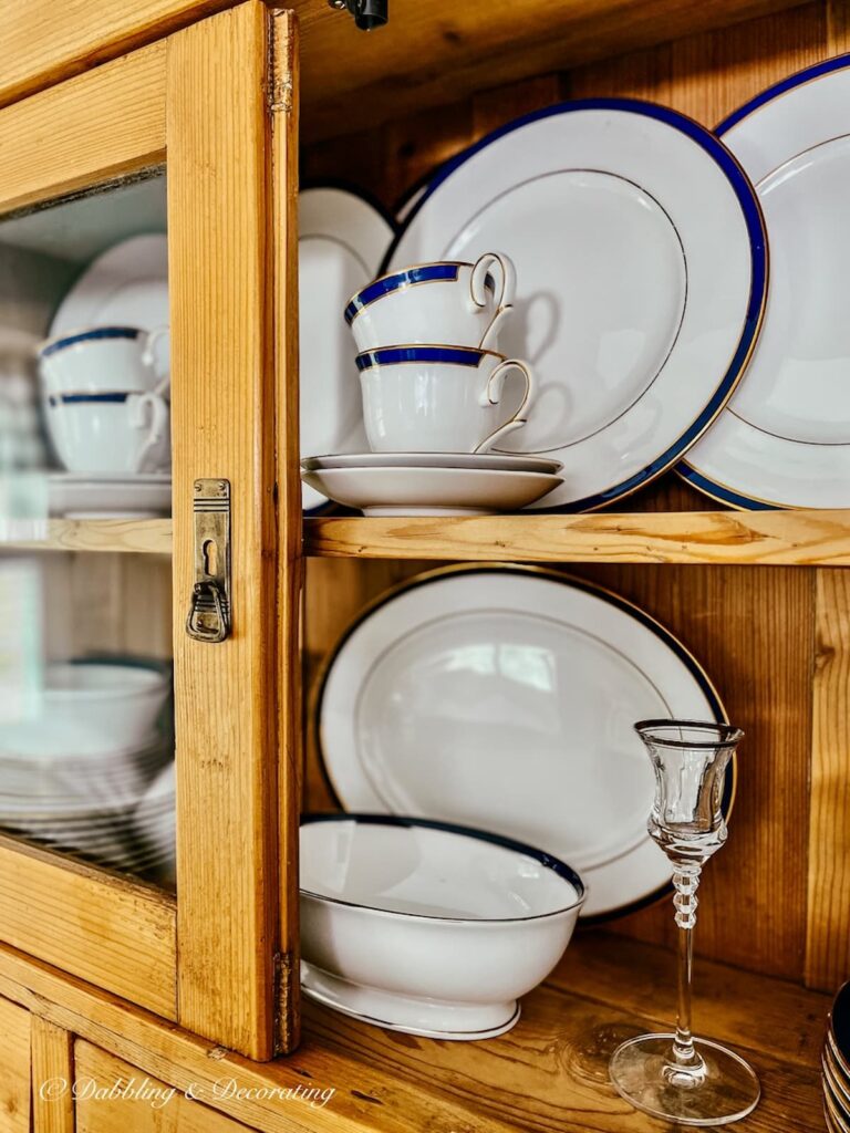 Blue and white china display in vintage china hutch.