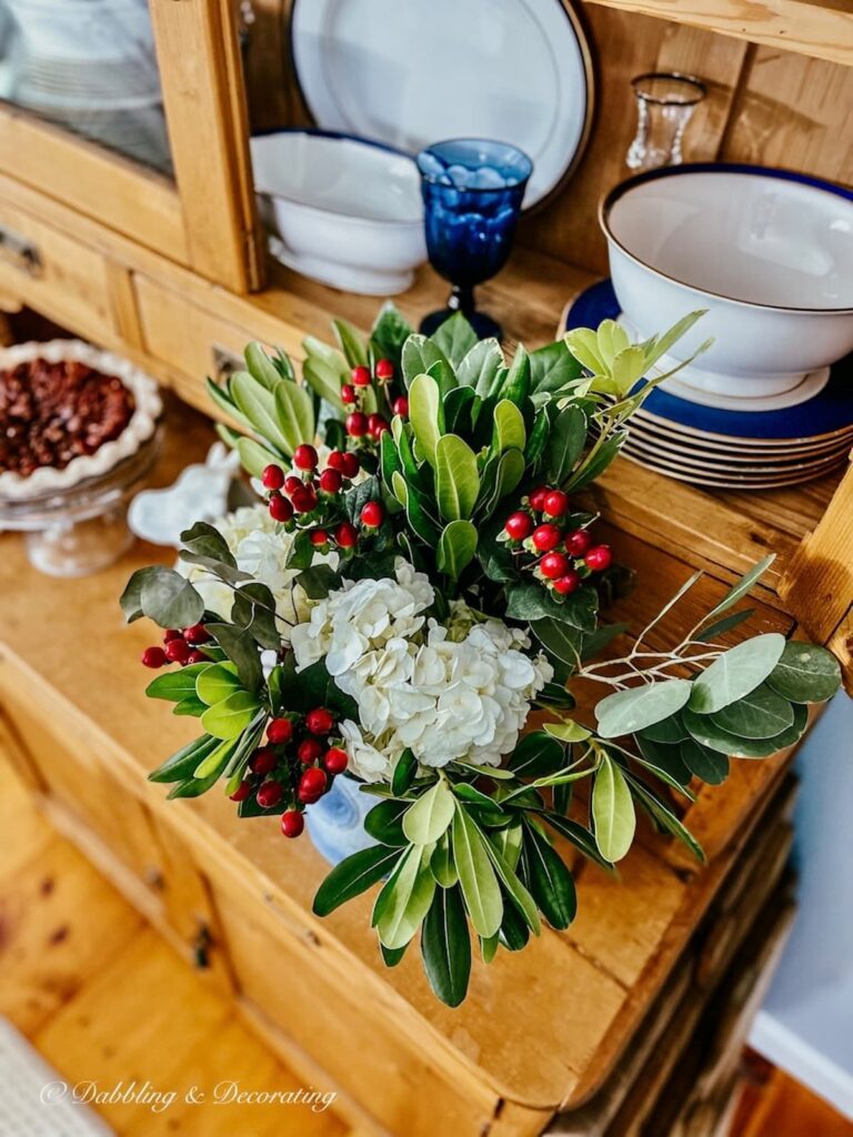 Bouquet of Flowers on antique china hutch.