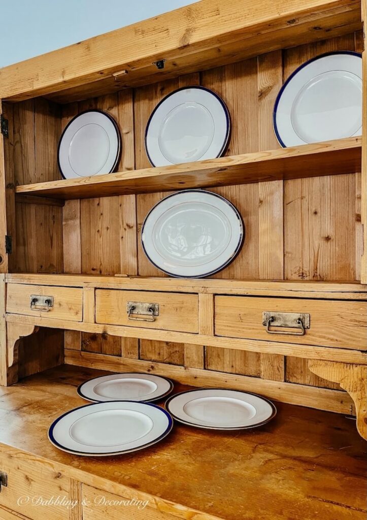 Vintage China Hutch with scattered china plates on shelving.