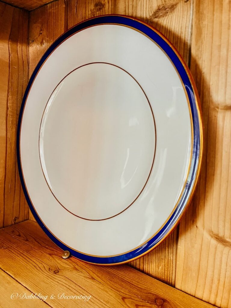 China Plate with Thumbtack in Vintage China Hutch