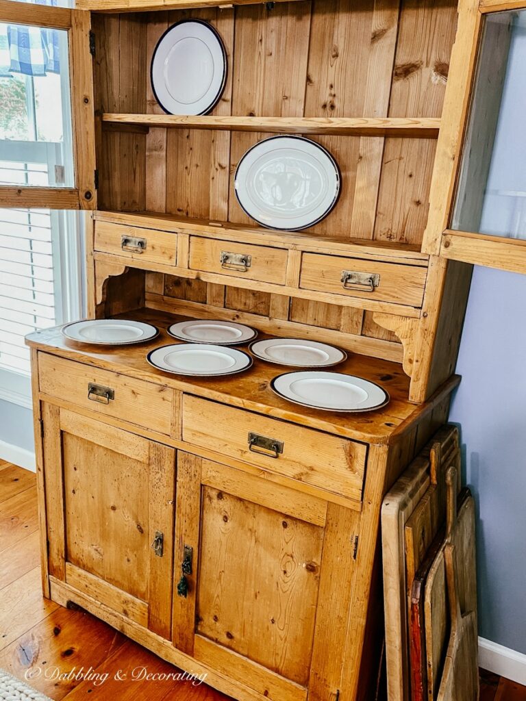 Vintage China Hutch with scattered china plates.