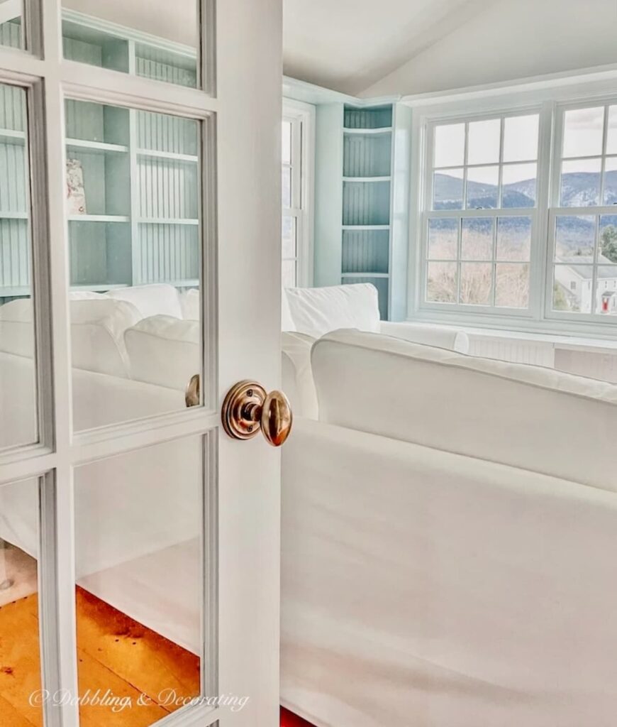 Benjamin Moore Sunroom Paint Colors That Work, Our Wedgewood Gray Makeover with Chantilly Lace and White sectional with open door.