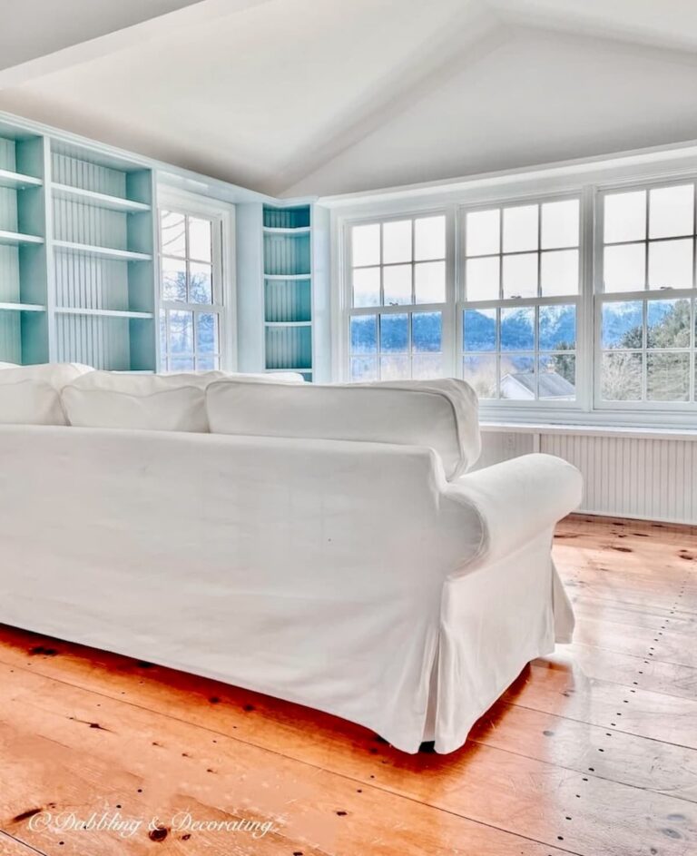 Benjamin Moore Sunroom Paint Colors That Work, Our Wedgewood Gray Makeover with Chantilly Lace and white sectional with wood floors and mountain views.