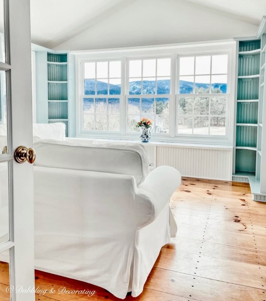 Benjamin Moore Sunroom Paint Colors That Work, Our Wedgewood Gray Makeover with Chantilly Lace reveal with wood floors and mountain views.