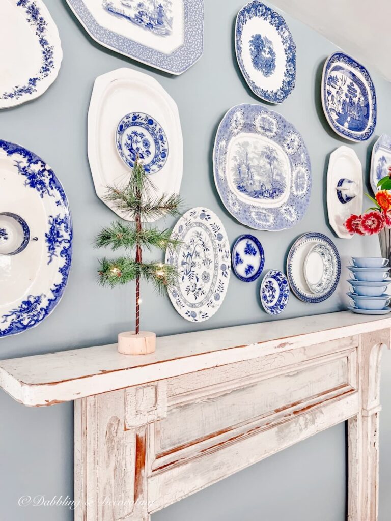 Blue and White Asymmetrical Vintage Platter Wall on Sherwin Williams Stardew wall.