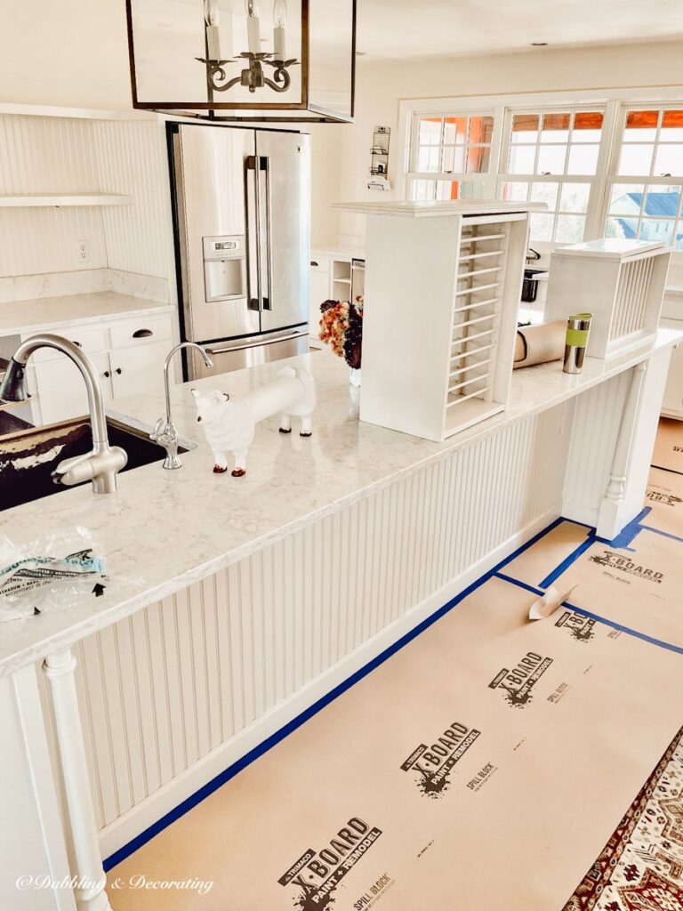 Open floor white kitchen in preparations for full open floor paint makeover with Sherwin Williams Stardew.