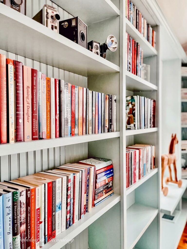 Built-in Bookcases with vintage eclectic decor and books.