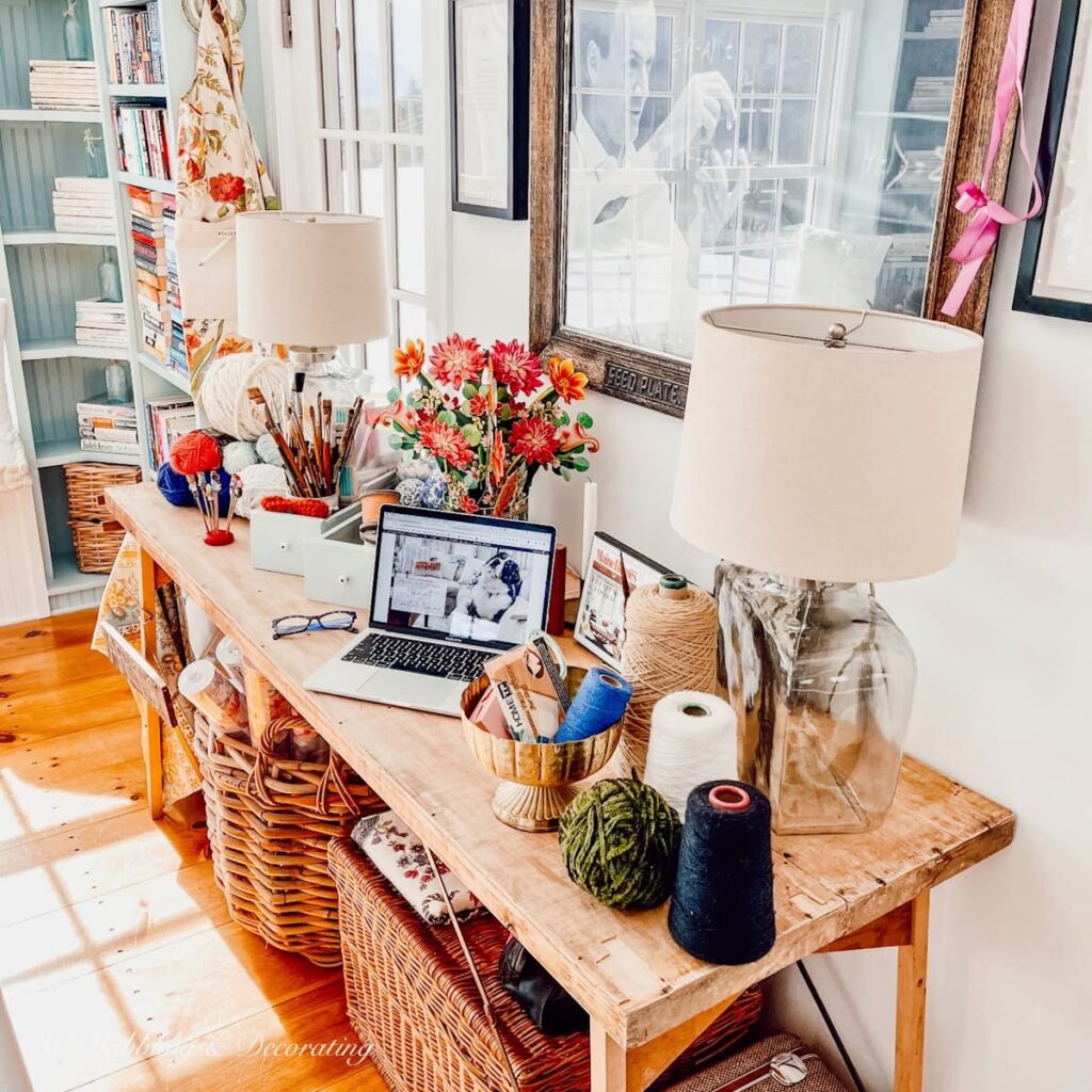 Vintage Wallpaper table with vintage eclectic accessories in craft room.