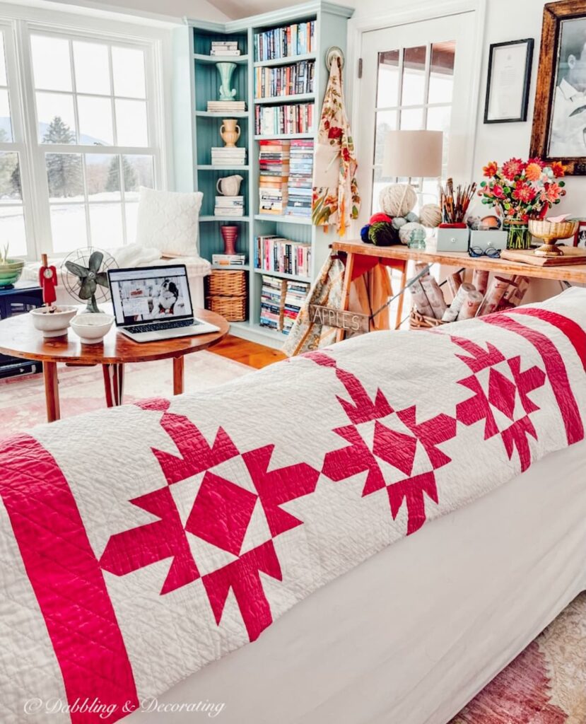 Pink and White Vintage Quilt in eclectic craft room.