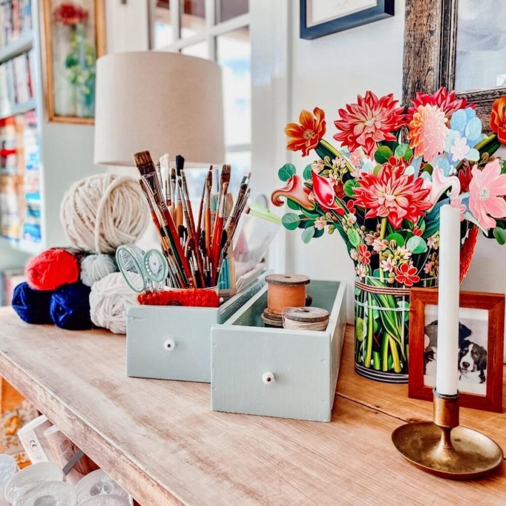 Vintage Eclectic colorful accessories on craft room desk.