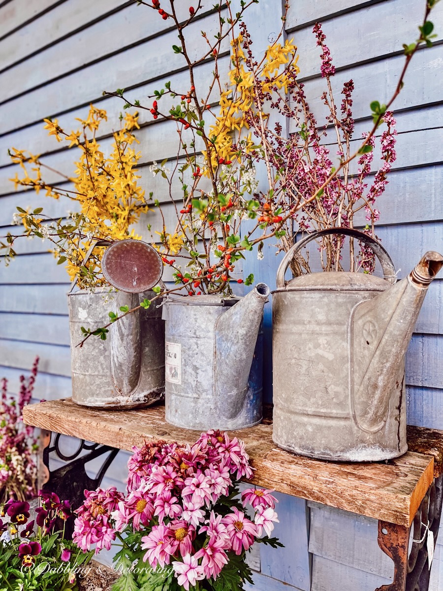 Vintage flower arrangements in metal Watering Cans