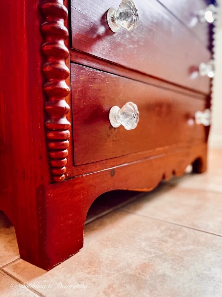 A Petite Wooden Antique Dresser in the Bathroom