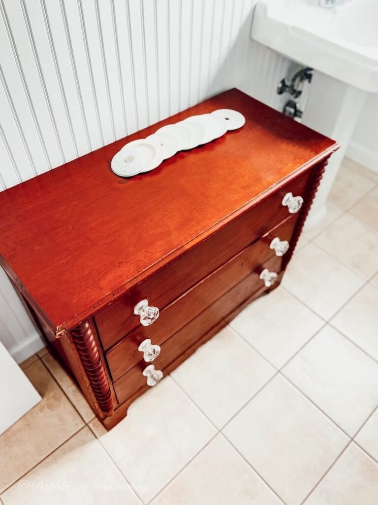 A Petite Wooden Antique Dresser in the Bathroom
