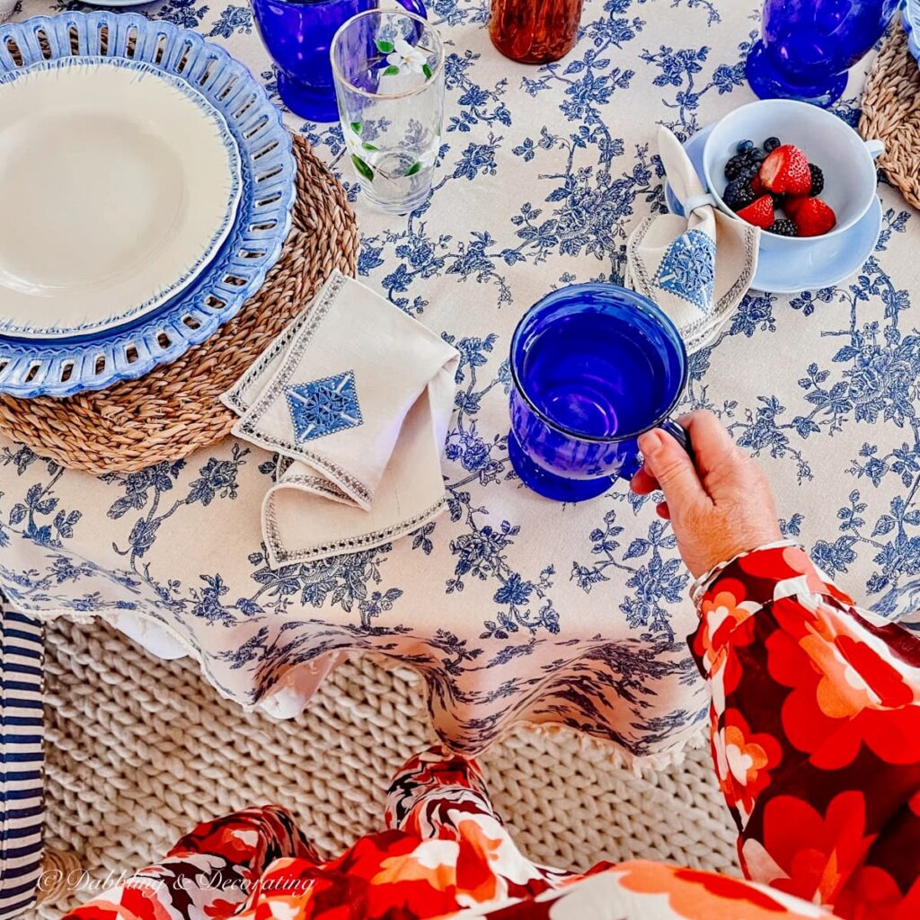 Breakfast nook table setting with blue mug of water.