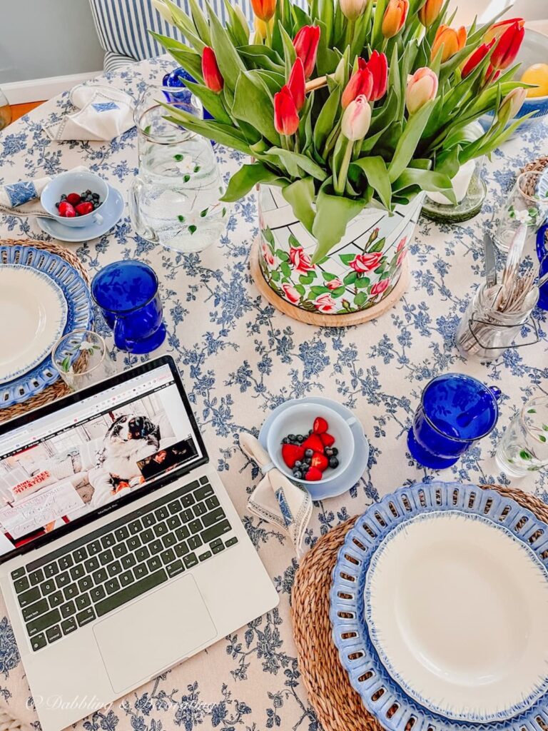 Breakfast Nook table with laptop, flowers and breakfast