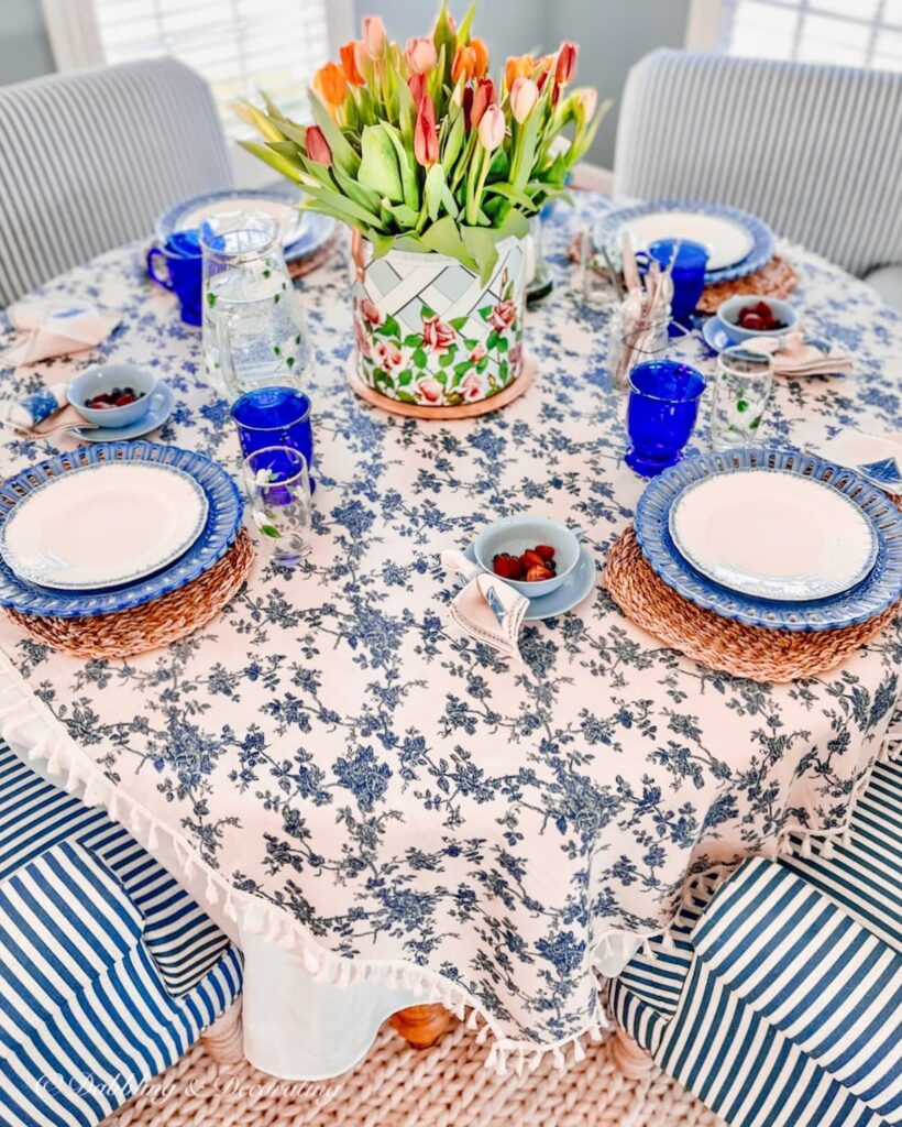 Breakfast nook ideas in blue and white with vintage layers, cozy white rug and blue and white striped chairs with spring centerpiece.