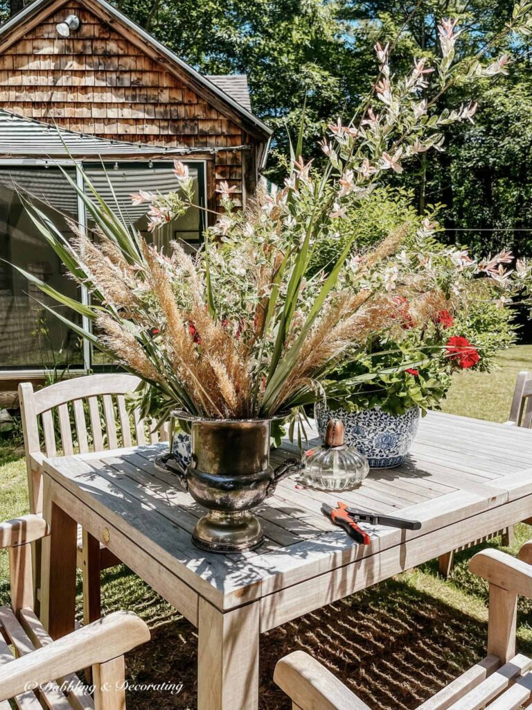 Summer Wildflower Arrangement in the making on outdoor Table.