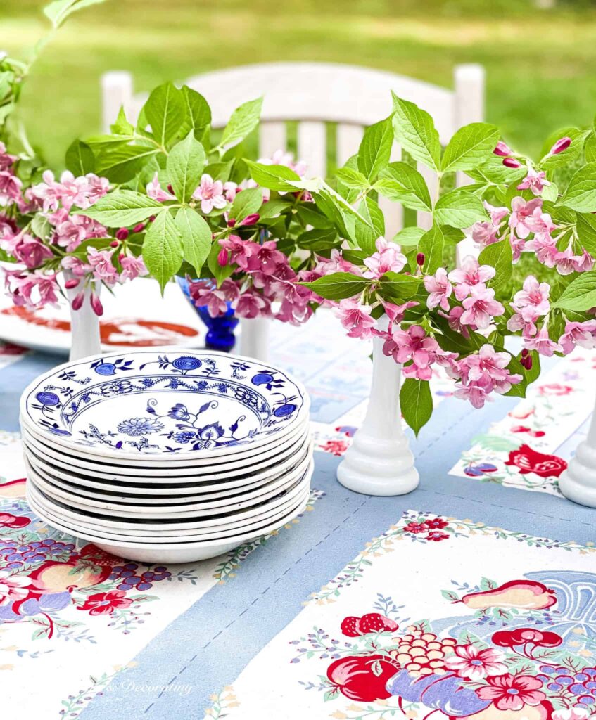 Old Fashioned Weigela Wildflower Arrangements in white milk glass on table.