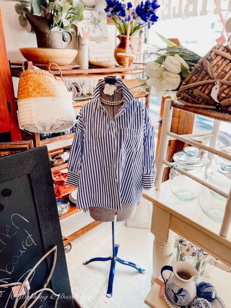 Dress Form Mannequin in Window Display with Blue and White Striped Blouse and Pearls.