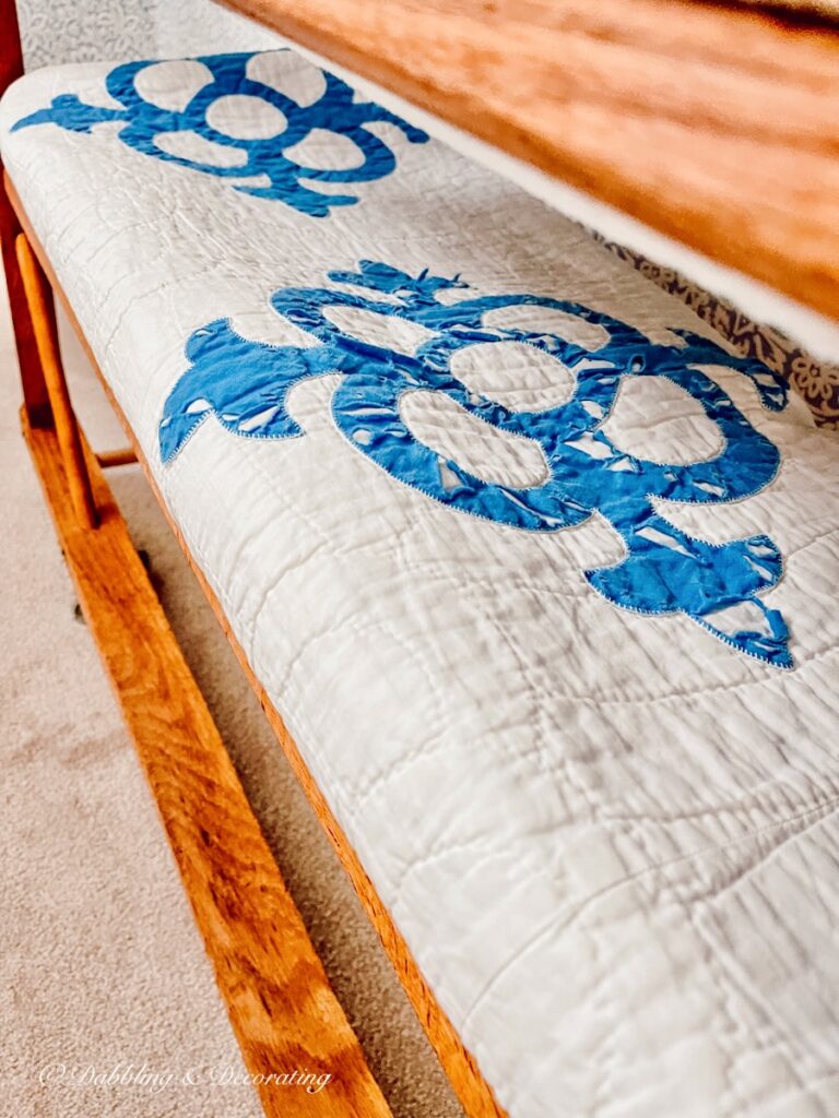 Vintage Quilt in wooden cobbler rack.