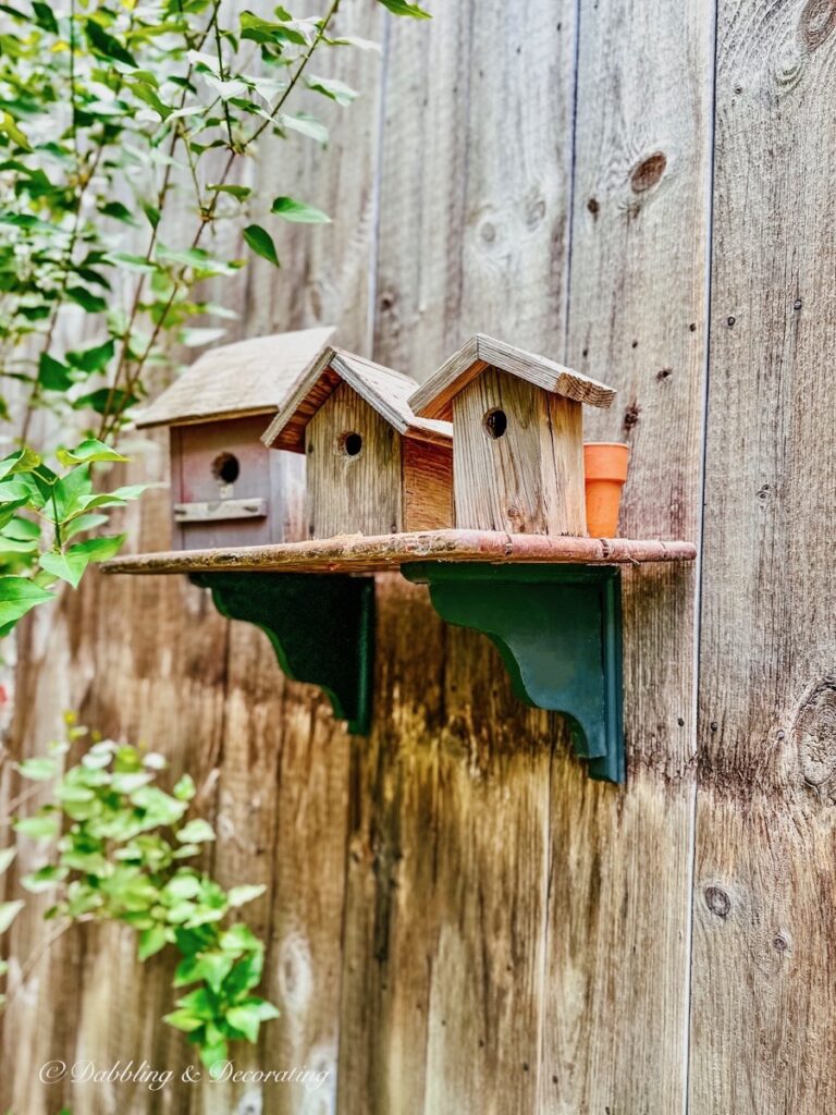 3 birdhouses on shelf