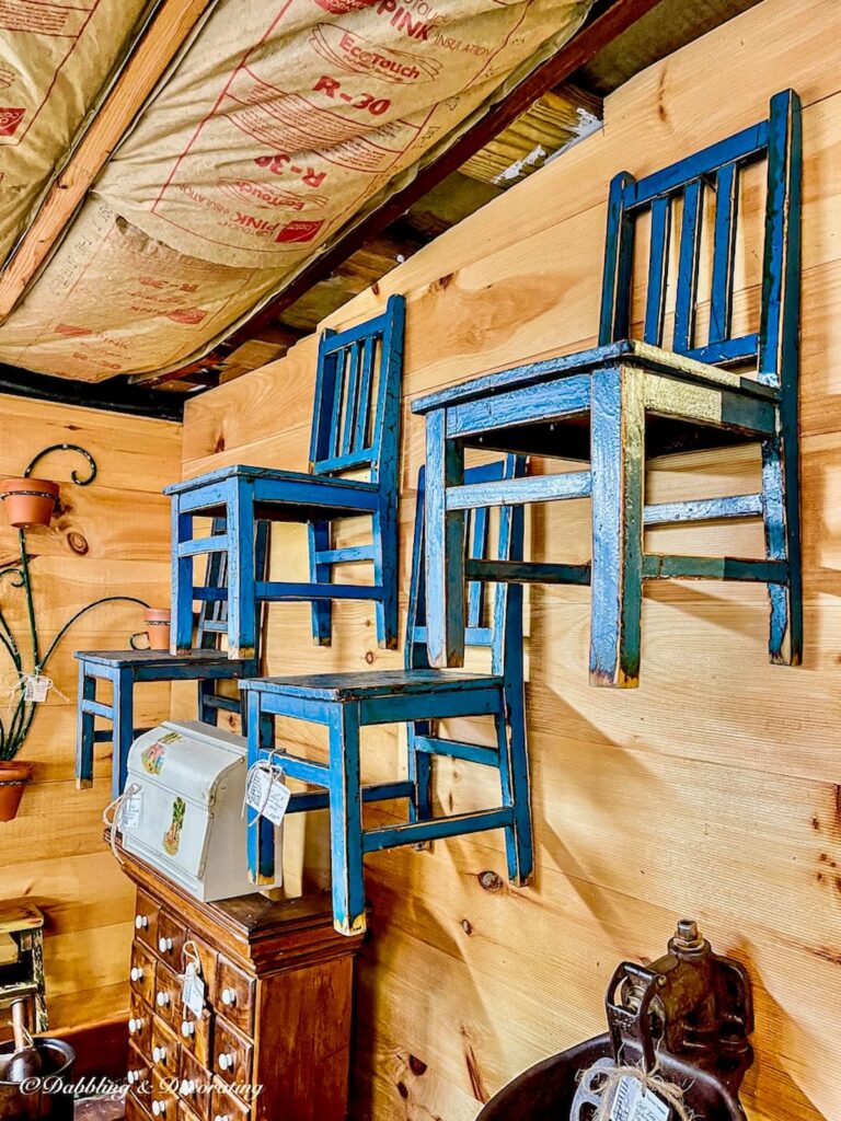 3 blue wooden chairs