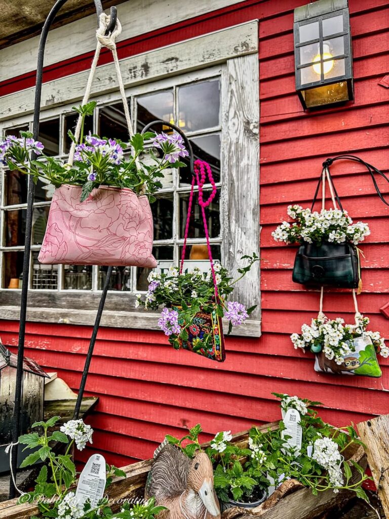 Various hanging pocketbooks with garden flowers