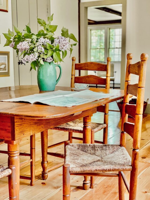 Colonial House Drawings with Lilac Bouquet on Dining Room Table.